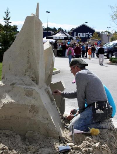 Sean Fitzpatrick of Fitzy Snowman Sculpting built a sand sculpture of what the World Trade Center site will look like after rebuilding is complete. BY JAIME REBHAN