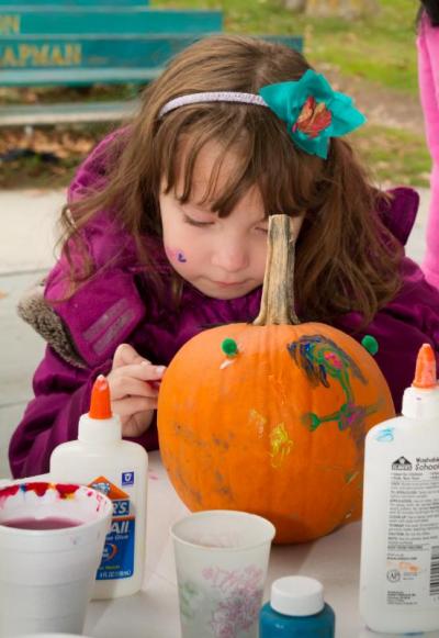 Abigail Morrison, age 5, paints a pumpkin during Onset Bay Association's Family Fun Day. BY ANDREW W. GRIFFITH