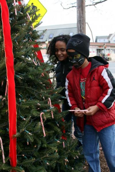 Cousins Randi Rose and Jayvn Harris (front), both 7 years old, listened to the Onset Bay Association's talking Christmas tree. BY JAIME REBHAN