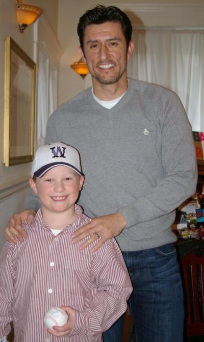 Garciaparra poses with smiling Wareham Little League player Gabe DeBlois while signing autographs before the question and answer session. BY RISHI SIDHU