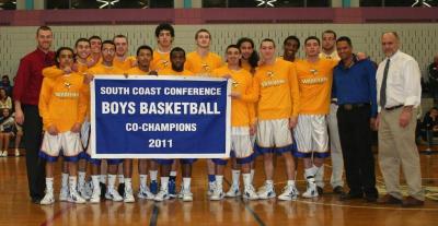 The players of the varsity boys basketball team pose with their 2011 championship banner before the big game. Wareham were SCC co-champions with Dighton-Rehoboth in 2011. COURTESY LORI CONNOR