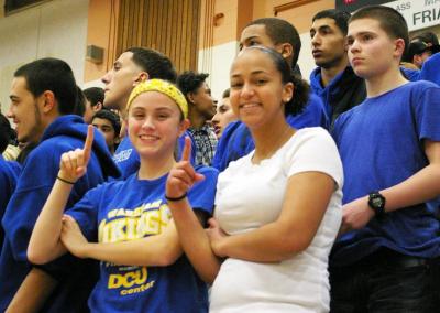Wareham girls basketball sophomore Breanna Muir (left) and friend Kamri Lopes signal that their team is number 1 during the Wareham-Taunton March 7 match-up. BY RISHI SIDHU