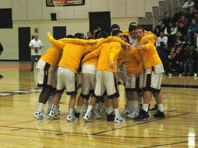 Wareham varsity boys basketball team eagerly wait for teammate Jeff Houde during the traditional pre-game motivational rally. BY RISHI SIDHU