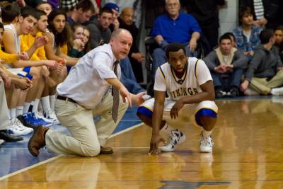 With the time running out in the game, Wareham Head Coach Kevin Brogioli talks last minute strategy with Vikings junior Darien Fernandes. BY ANDREW GRIFFITH