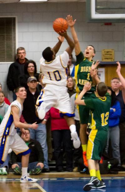 Darien Fernandes takes it to the hoop as Falcons captain Dylan Barbosa goes up for the block. BY ANDREW GRIFFITH