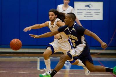 Tyler Gomes races Foxboro Senior Jeff McPherson for a loose ball in the Vikings win on Wednesday. BY ANDREW W. GRIFFITH