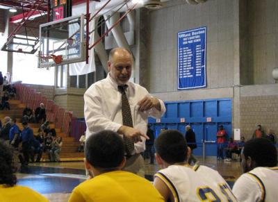 Coach Kevin Brogioli keeping is players loose before the start of Saturday's game against Martha's Vineyard at UMass Boston. BY PATRICK LESTER