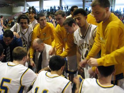 Plays huddle around head coach Kevin Brogioli and assistance coach Larry Senna during Saturday's game at UMass Boston BY PATRICK LESTER