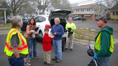 Volunteers of the Wareham Area Litter Mob plan out their day during their April 22 clean-up of Onset Avenue. BY RISHI SIDHU