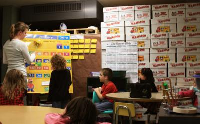 The school department is seeking a debt exclusion to fund a feasibility study for renovations to Minot Forest Elementary School. In this 2010 photo, a Minot Forest teacher instructs students in a shower room. The room, which still has shower nozzles, is now used for both instruction and office space. BY JAIME REBHAN