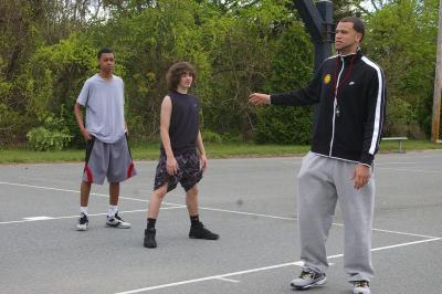 Colbey Santos introduces the "8 Lines of Fun" to Wareham High School freshman Michael Labonte (middle) and Derrick Guerrier (left) during Sunday's basketball clinic and fundraiser. BY RISHI SIDHU