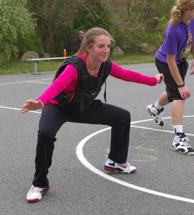 Michaela McDuffy, 14, practices her defensive stance while wearing a 20 pound vest. McDuffy, who has been taking personal lessons from Santos, said that she became captain of her JV team at Upper Cape Cod Regional Technical High School as a result of her lessons. BY RISHI SIDHU