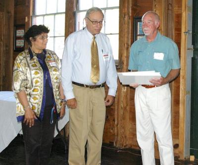 From left to right, representatives from the Oak Grove Cape Verdean Cultural Center Organization, Marian Rose and Vice President John Santiago, receive a $5,000 award which will go towards the Building Fund for the Oak Grove Cultural Center on Onset Avenue. BY RISHI SIDHU