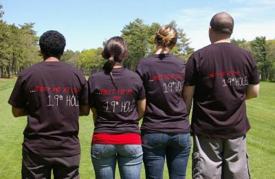 4 high school friends of Scotty Monteiro Jr. wear t-shirts that say "Meet Me at the 19th Hole," with the 19th hole meaning the Clubhouse bar. From left to right, Hasani Pilgrim, Angie Kight, Amanda Austin, and Peter Brousseau. BY RISHI SIDHU
