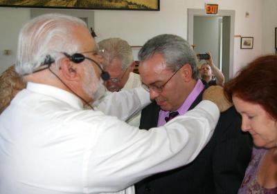 Pastor Bob Cordeiro receives his ordainment from Apostle Tony Rezendes during a ceremony on Sunday, May 27 at the Old Methodist Meeting House in Wareham. BY RISHI SIDHU