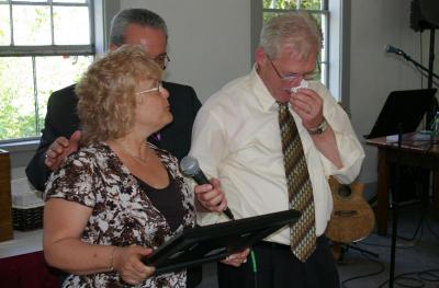 Mark Porter wipes off tears as he attempts to make a speech after receiving his license for ministry along with wife Jan Porter. BY RISHI SIDHU