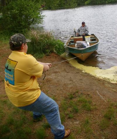 12 year old Brandon Lake pulls in his grandfather as well as fish they caught during the day at the end of the fishing derby on Sunday. BY RISHI SIDHU