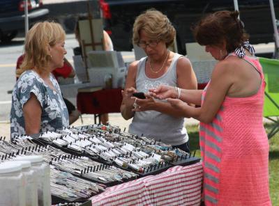Visitors browsed the offerings at the first Onset Market Day. The farmers' and artisans' market will be held every Wednesday from 12:30 p.m. until 4:30 p.m. BY JAIME REBHAN