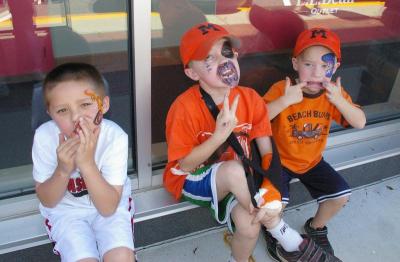 From left to right, 7-year-old Braden Borromeo, 7-year-old Justin Tullish, and 3-year-old Ryan Tullish, all from Middleboro, show the faces they made while getting their pictures taken in the photo booth. BY RISHI SIDHU