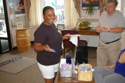 Donna Cardoza shows off some goodies she received in Eastern Bank on Main Street during "Main Street Madness" held on Friday, July 20. BY RISHI SIDHU