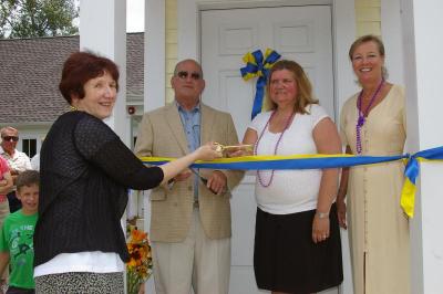 Priscilla Porter, member of the Friends of the Wareham Free Library, passes the ceremonial key to Denise Medeiros, Director of the Wareham Free Library. BY RISHI SIDHU