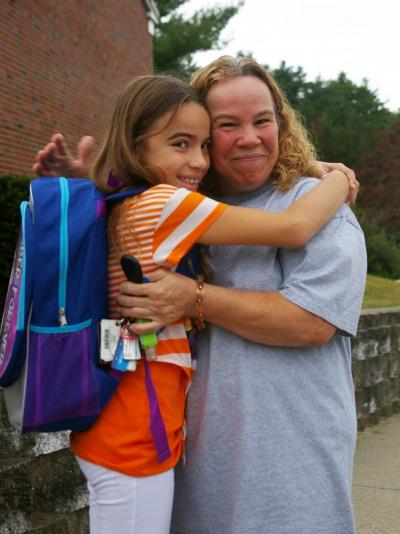 Fifth grader Ariana Rodriguez says goodbye to her grandmother, Wanda Rodriguez, as she arrives at Minot Forest Elementary School. BY RISHI SIDHU