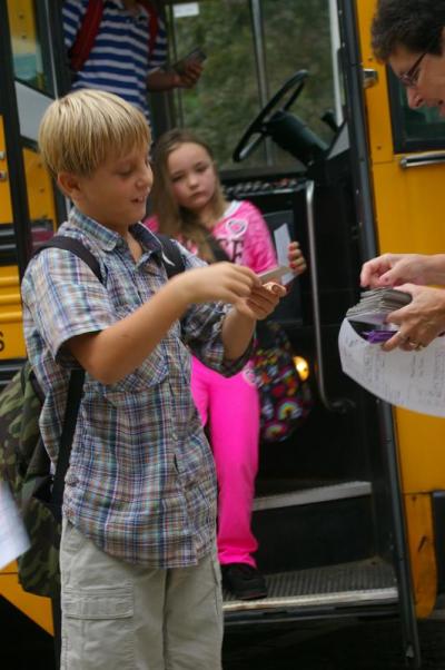 Second grader Brenden Behring gets off the bus and arrives at Minot Forest Elementary School. Teachers gave the students cards as soon as they arrived telling them which bus to take home so they wouldn't forget! BY RISHI SIDHU