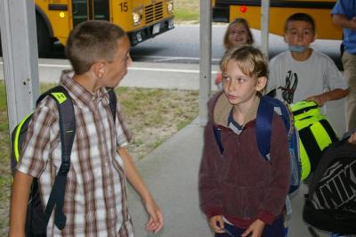 Third grader Michael Johnson talks to fellow third grader Stephen Sprague as they arrive at Minot Forest Elementary School. BY RISHI SIDHU