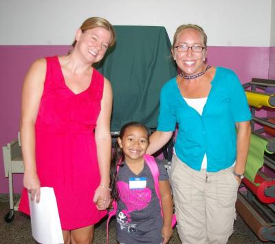 First-grader Samara Machicote gets dropped off to class by Minot Forest teachers Crystal Carson (left) and kindergarten teacher Maggie Kuppens. BY RISHI SIDHU