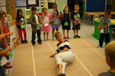 Decas Elementary School First Grade Teacher Dori Kais teaches her students the wrong way to sit during the first day of class. BY RISHI SIDHU