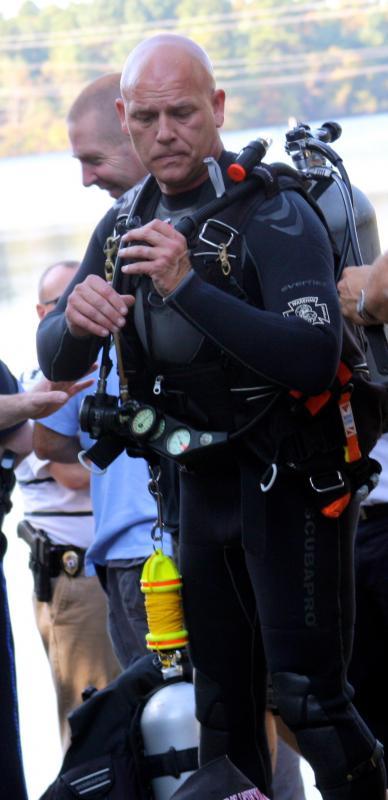 Wareham Fire Department divers suited up to check out the Isuzu SUV that was approximately 10 feet below the surface of Tihonet Pond. BY JAIME REBHAN