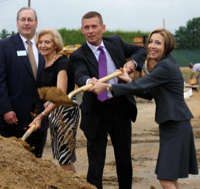 A.D. Makepeace president and CEO Michael Hogan and Cape Cod Five president and CEO Dorothy Savarese, far right, shovel dirt at the ceremonial groundbreaking of Rosebrook Place. BY JAIME REBHAN