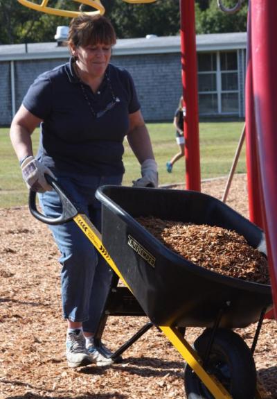 Principal Christine Panarese is caught off guard by Wareham Week's camera during the playground build on Saturday. BY JAIME REBHAN