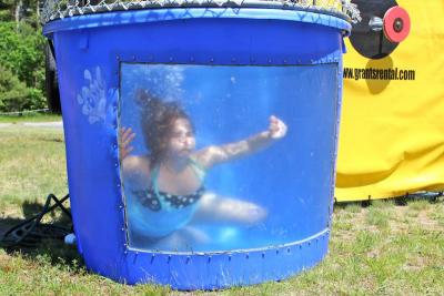 Volunteer Amanda Leite is the first to get dunked in the dunk tank at Family Fun Day Sunday morning. BY NICK WALECKA