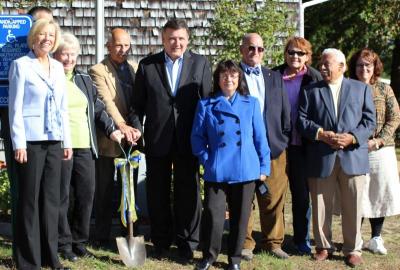 From left: State Rep. Susan Gifford, acting Associate Director of Housing and Rental Assistance Steve Carvahlo (obstructed), CEDA Board Chair Jean Connaughton, Housing Authority Board Chair Bob Powilatis, Senator Marc Pacheco, Historical Society Chair Angela Dunham, Selectman Alan Slavin, Housing Authority Board member Donna Bronk, Housing Authority Board member Rudy Santos, and Housing Authority Executive Director Jackie Hickey. BY NICK WALECKA