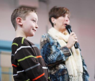 Brendan Spenard looks on with a smile as his principal, Donna Noonan, speaks about his service to the community. BY NICK WALECKA