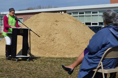 Amanda DaCruz (background) addresses the crowd during the groundbreaking ceremony. Attendees included Superintendent Kimberly Shaver-Hood (foreground). BY SETH THOMAS
