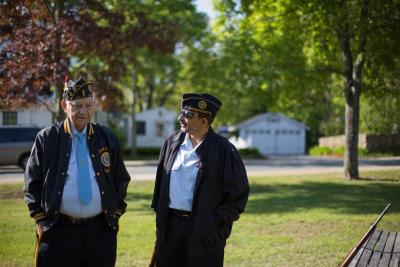 Joe Capello, left, and John Monteiro speak, before the ceremony begins on the Town Green. BY CAROLYN BICK