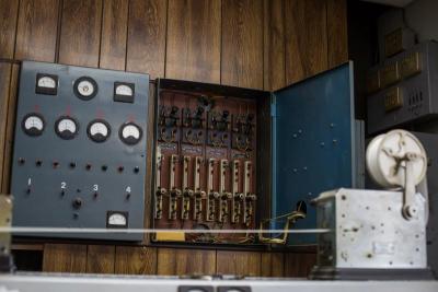 An old switchbox, which Chief Goodwin calls "the Frankenstein switches", sits on a wall, behind a machine made in Galveston, Texas, in the 1940s. The station still uses both machines. BY CAROLYN BICK