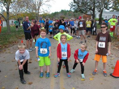 Young runners getting themselves ready for their race. They all said they were ready to win. BY PATRICK LESTER