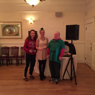 Sally Morrison’s best buddy Patrick Rooney, right, presents a $1,000 check to Sasha Miceli and Emily Chambers, of Wareham High School’s Best Buddies. Rooney's grandmother died last summer, but contributed to themed fabric murals, quilts and crochet items to all 10 Tastes & Sounds auctions. COURTESY SALLY MORRISON