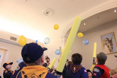 Cub Scouts keep blue and gold balloons in the air with their blue and gold lightsabers. BY ZARRIN TASNIM AHMED