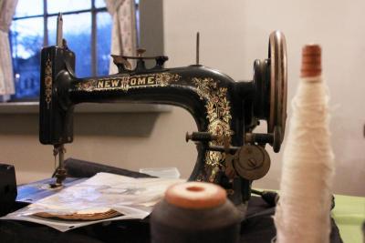 An old sewing machine sits atop a table filled with sewing materials during the Wareham Historical Society's quilting talk. BY ZARRIN TASNIM AHMED