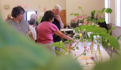 Attendees of the Small Standard Flower Show included many Wareham Garden Club members, who looked closely at each specimen on the table. BY ZARRIN TASNIM AHMED