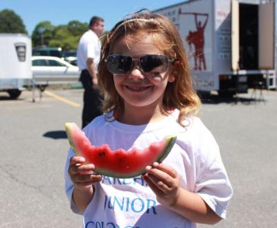 Emma Pacheco, 8, was the flag bearer for the event and is part of the Color Guard. Here, she's enjoying a watermelon. BY ZARRIN TASNIM AHMED