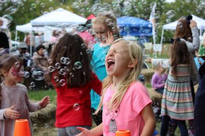 Zoey Knights, age 4 of Plymouth, catches some bubbles during a kids show on Saturday. BY MATTHEW BERNAT