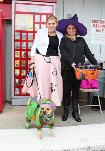 Danielle Tester, left, and Nancy Lugo, along with Tester's puggle, Belichick, stand outside of Cumberland Farms. BY MATTHEW BERNAT