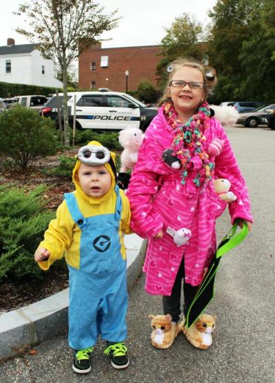 Carter and Lily Franklin pause for a photograph. Carter is a Minion and, in Lily's words: "I'm a crazy cat lady. I love cats and they're crawling all over me!" BY MATTHEW BERNAT