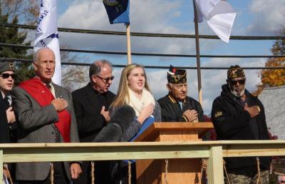 Sarah Gallagher, vice president of the Wareham High School Key Club, leads the crowd in the Pledge of Allegiance. BY MATTHEW BERNAT