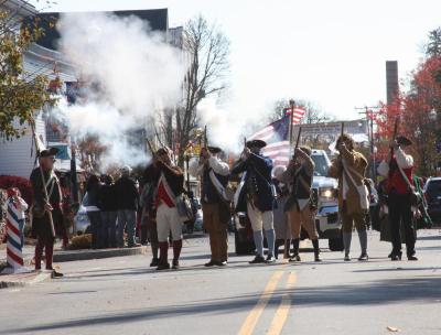 Members of the Wareham Militia fire off a round as the parade makes its way down Main Street. BY MATTHEW BERNAT